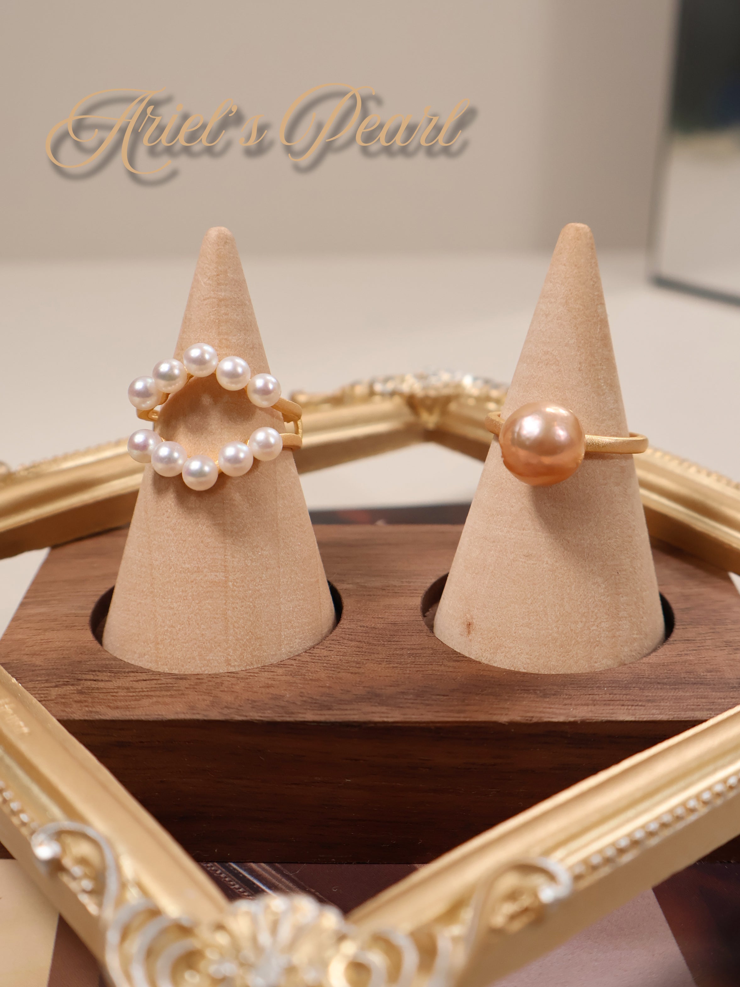Set of pearl rings when it wear separately on wooden cone stands with 'Ariel's Pearl' branding.